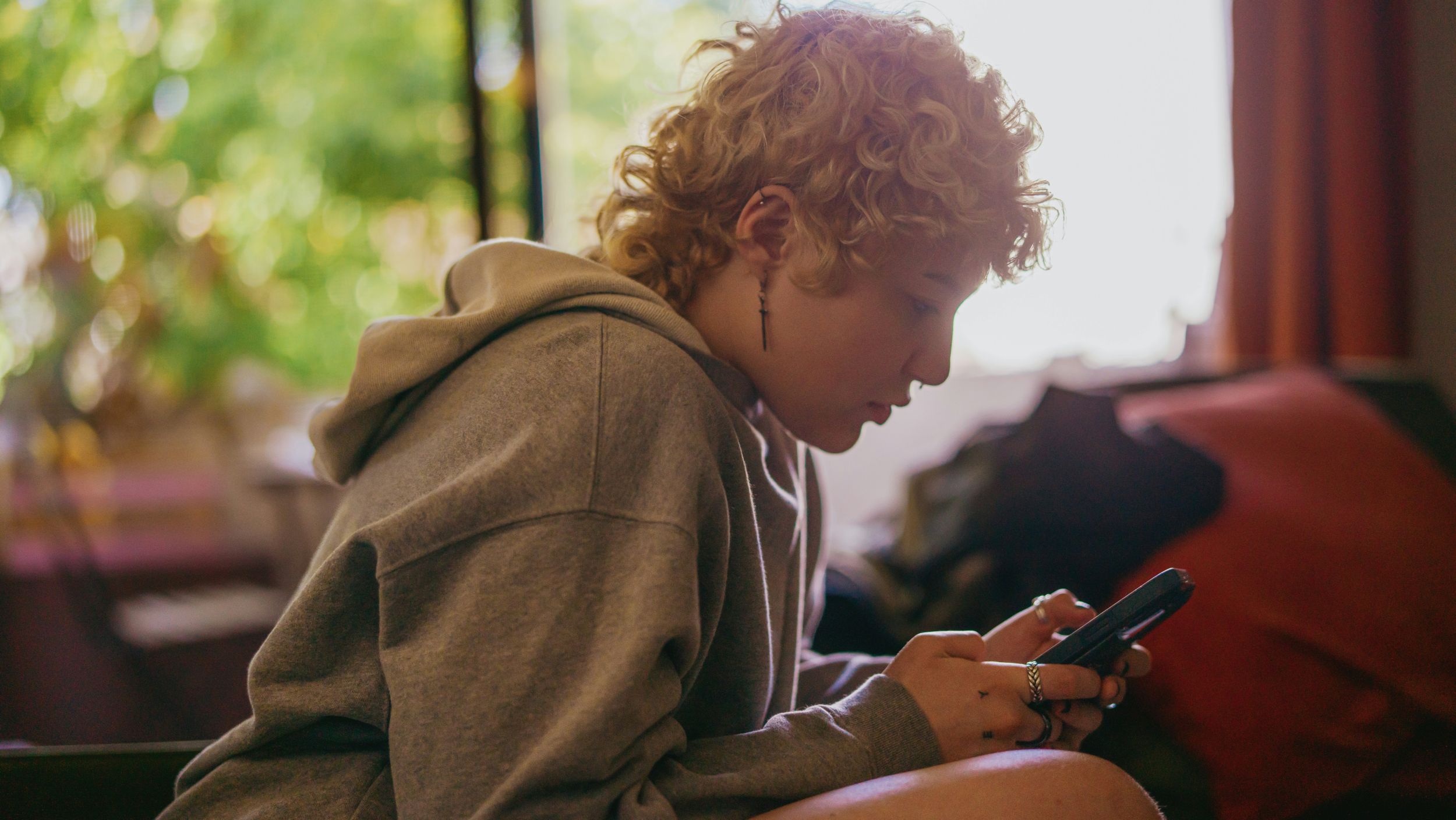 Person on phone, texting.